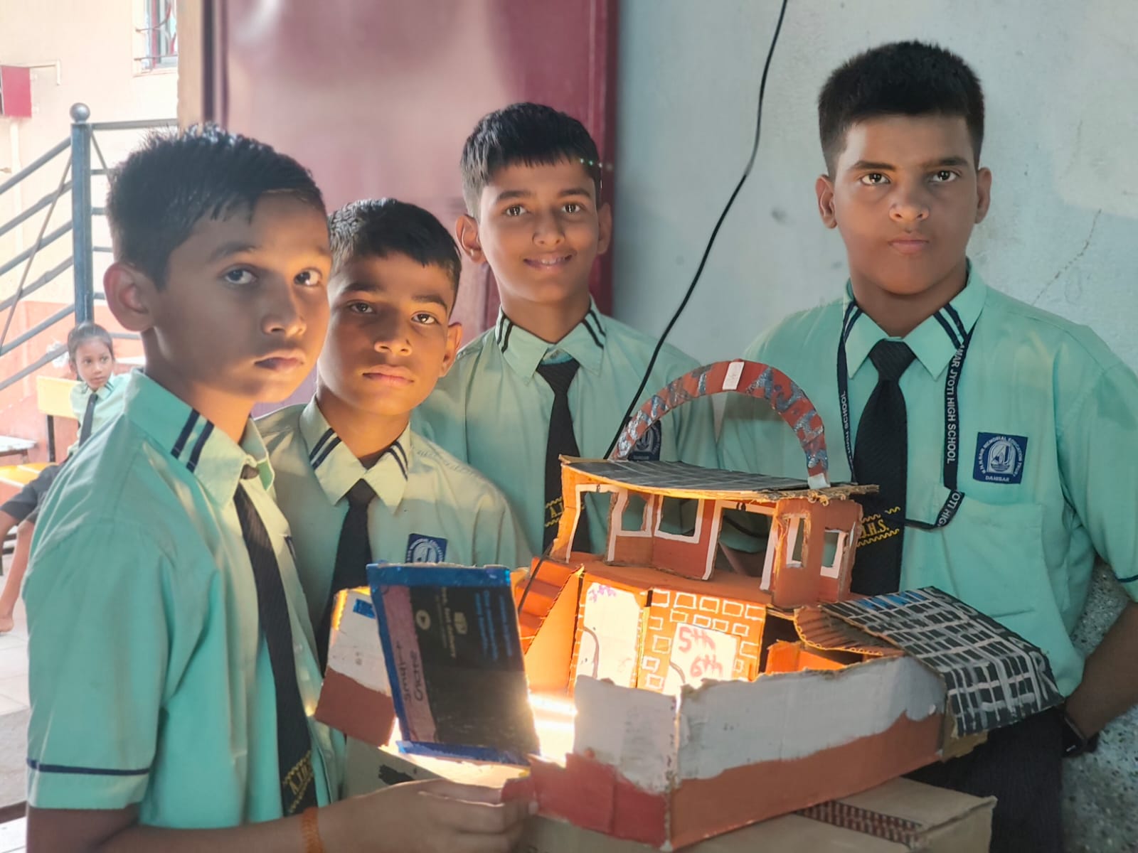 Students presenting a handmade educational model